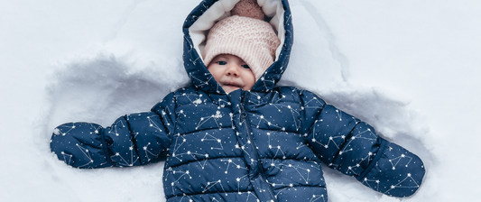 baby in warm clothes in the snow
