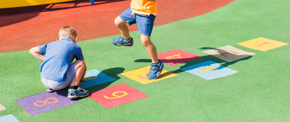 two children playing hopscotch