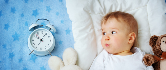 baby looking at a clock