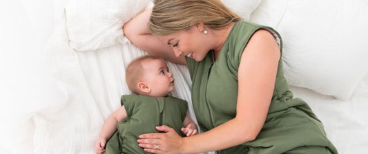 mum and baby in bed with green Slumbersac sleeping bags on