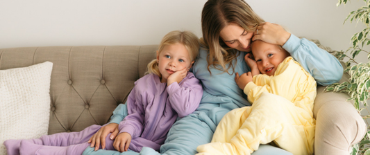 mum with her children wearing sleeping bags with feet