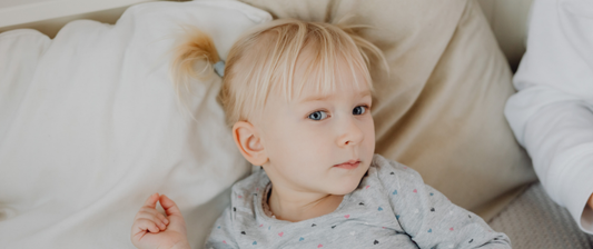 young toddler girl in bed