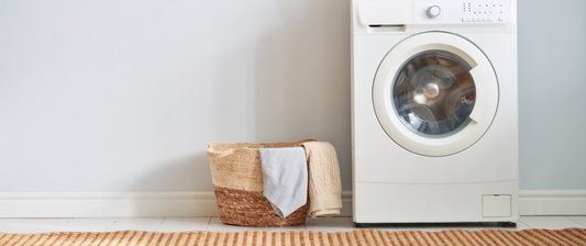 washing machine with basket of baby clothing