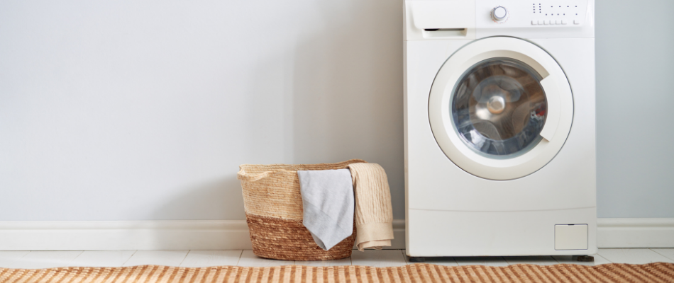 washing machine with basket of baby clothing