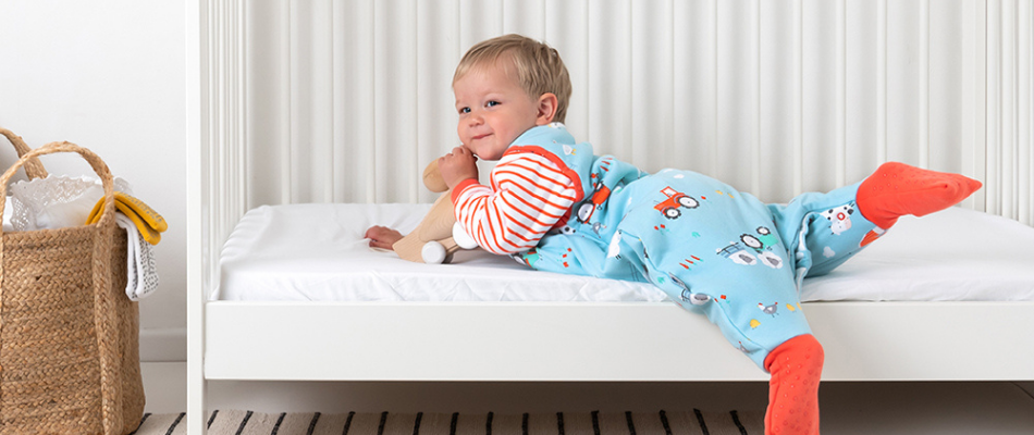 toddler laying on cot in Slumbersac