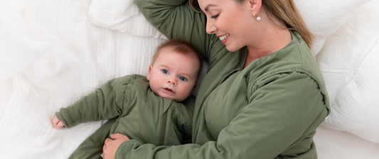 mum sleeping with her baby in olive green sleeping bags