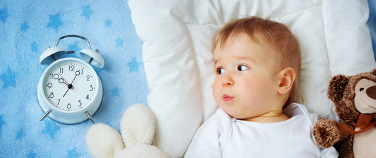 baby looking at clock