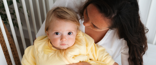 mum and baby in yellow sleeping bag