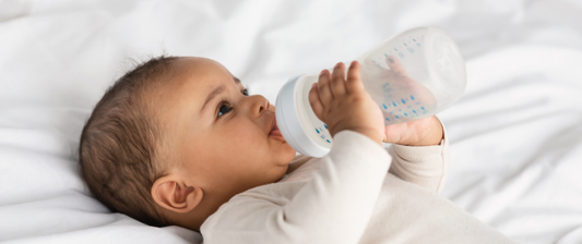 baby drinking from milk bottle