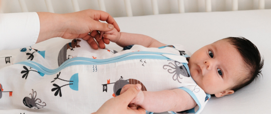 baby in white and blue pirate baby sleeping bag