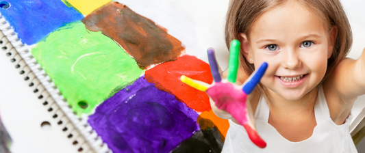 girl with painted hand in bright colours