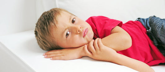 boy lying down looking defiant