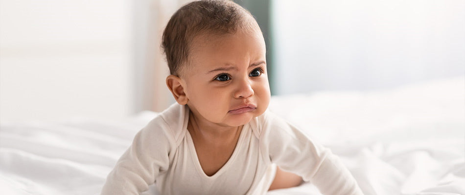 baby crawling and looking frustrated