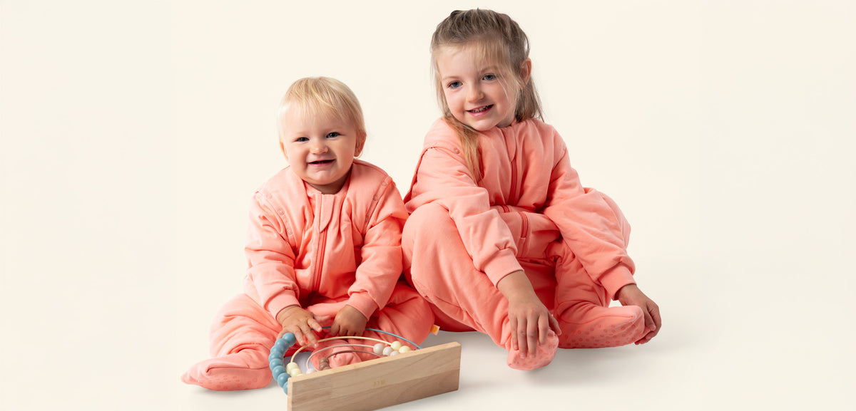 Mainpage Banner Peach Design Desktop - Kids in a Peach Sleeping Bag with Feet