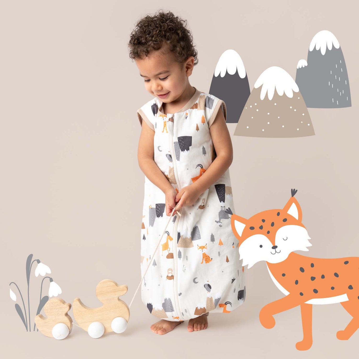 boy wearing mountain animals sleeping bag with feet